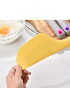 Close-up of a yellow silicone spatula showing its flexibility and durable texture for baking