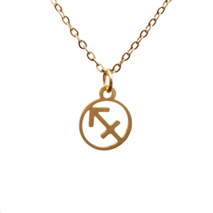 Detail of a gold titanium steel Sagittarius constellation necklace with a hollow arrow coin