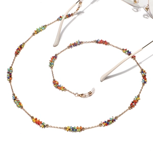 Handmade gold eyewear chain with multi-colored beads for glasses and masks on white background