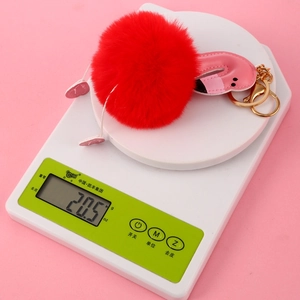Flamingo faux fur pompom keychain with pink leather detail weighing 20.5 grams
