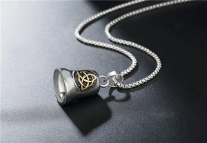 Detail of viking bell pendant with golden celtic knot and silver box chain necklace
