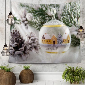 Christmas tapestry detail showing a snowy cabin inside a festive globe on a gray wall