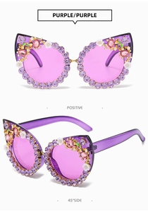 Detail view of purple cat eye sunglasses with rhinestones, gold bees, and floral accents