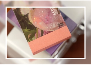 Close-up of sticker book cover with pink peony design and frosted orange texture