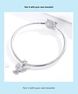 Detail of S925 sterling silver snake chain bracelet with crystal owl clasp and dove charm