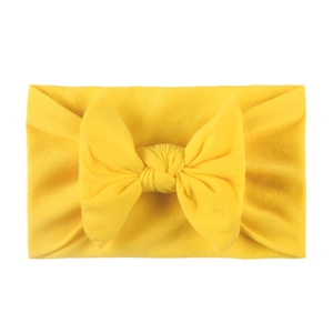 Soft yellow nylon baby headband with a large bow detail for infants and toddlers
