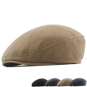 Detail view of herringbone tweed flat caps in black, grey, khaki, and navy blue