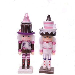 Pink and brown dessert-themed wooden Nutcracker figurines with cupcake and coffee cup hats