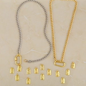Detail of silver and gold Cuban link chains with various DIY alphabet pendants