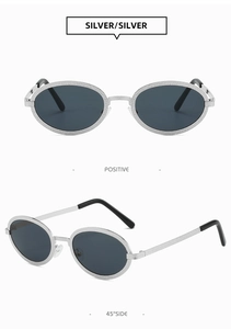 Detailed view of silver oval metal sunglasses with hammered texture and dark grey lenses