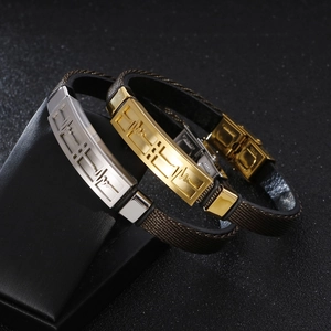Golden and silver heartbeat ECG bracelets with brown woven straps on a display stand