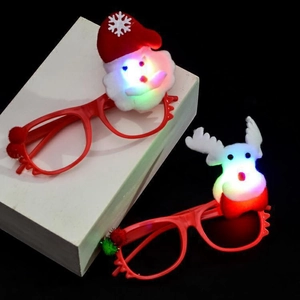 Detail of LED glowing Santa and Reindeer glasses with red frames on a black background