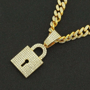 Golden Cuban link chain necklace with a sparkling diamond-encrusted padlock pendant