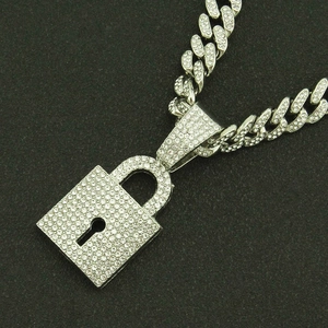 Detail of silver Cuban chain necklace with a rhinestone-encrusted padlock pendant
