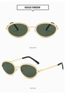 Detail of vintage oval metal sunglasses with gold textured frames and dark green lenses