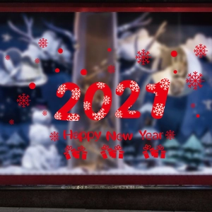 Detail showing red Happy New Year 2021 window clings with snowflakes and gift box motifs