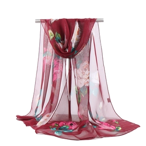 Detailed texture of sheer red lotus floral chiffon scarf showing lightweight fabric