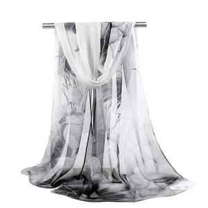 Detail of sheer georgette scarf showing elegant black and white ink lotus flower pattern