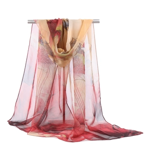 Close-up of lightweight chiffon lotus print scarf with red and beige gradient finish