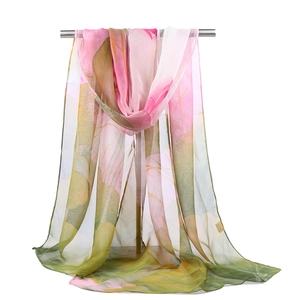 Close-up of lightweight chiffon lotus scarf draped over a bar showing semi-transparent texture
