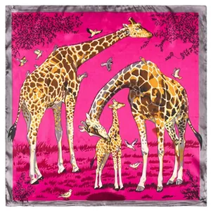 Detailed pattern of pink silk scarf featuring giraffe and bird motifs on a flat layout
