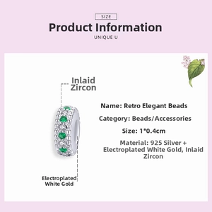 Macro shot of 925 sterling silver vintage charm with green and white cubic zirconia