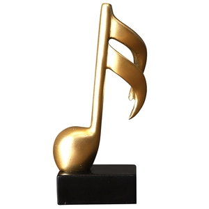 Elegant gold musical note sculpture on black base for modern home office desk decor