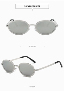 Detail of silver oval sunglasses with metallic frames and mirrored silver lenses