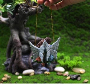 Macro detail of fairy angel garden miniatures with delicate wings and resin texture