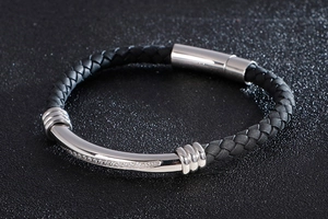 Close-up of black braided leather bracelet with silver curved tube and small crystals