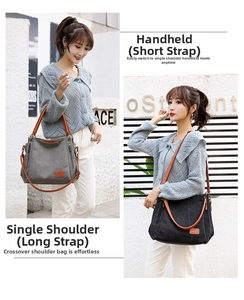 Detail of canvas tote bag showing adjustable shoulder strap and leather handles