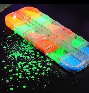 Luminous nail art sequins in a 12-grid storage box with glowing star and heart shapes