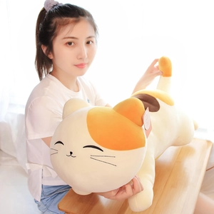 Long calico cat plush pillow with soft filling and cute smiling face held by a model