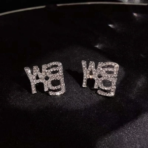 Luxurious S925 silver letter earrings with sparkling crystal pavé on black background
