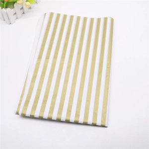 Detail showing metallic gold and white striped pattern on premium tissue paper