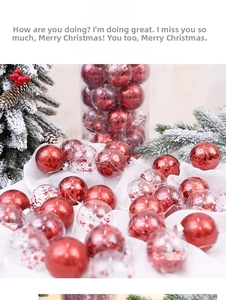 Close-up of assorted red and glitter Christmas ornaments on snowy pine needles
