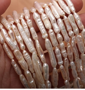 Macro shot of high-luster natural baroque pearls with unique threaded texture and long shape