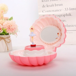 Detail of pink shell music box with dancing ballerina, mirror and cream base