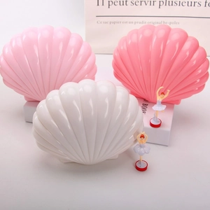 Detailed view of colorful shell music boxes with ballet dancers and glossy finish