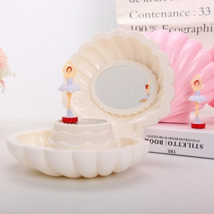 Close-up of shell music box with inner mirror and rotating ballerina dancer inside