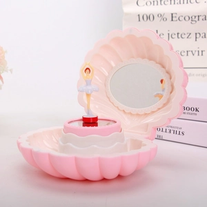 Detail of pink shell music box featuring a rotating ballerina and interior mirror
