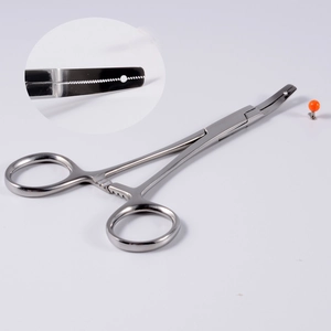 Macro detail of silver stainless steel surgical piercing forceps with locking mechanism