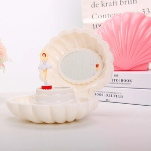 Detailed view of cream shell music box with rotating ballerina and vanity mirror detail