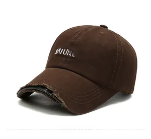 Close-up of distressed brim with Saturday embroidery on brown cotton baseball cap