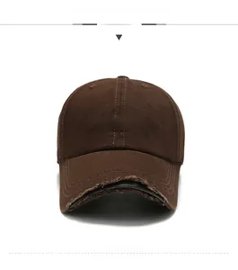 Detailed view of the distressed brim and white SATURDAY embroidery on the brown baseball cap