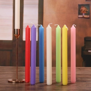 Close-up of seven assorted colorful taper candles on wood for elegant home decor