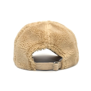 Detail of adjustable metal buckle and corduroy strap on beige fleece baseball cap