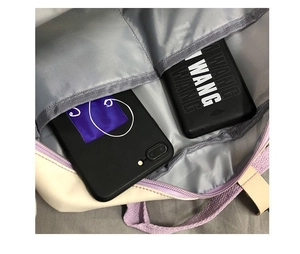 Detail view of the canvas bag's interior pockets showing phone and power bank storage