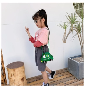 Detail of green police car shaped kids bag with POLICE lettering and adjustable strap