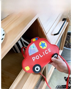 Close-up of kids red police car shoulder bag with reflective windows and silver details